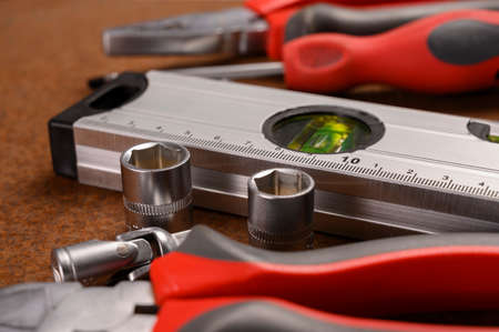 Set of tools on wooden background. Top view with copy space.