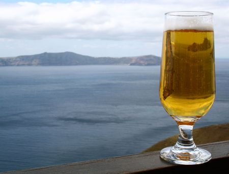 Glass of bear in the cafe above the Santorini's Calderaの写真素材