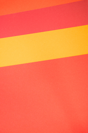 Yellow, red and orange vertical color paper, abstract background in three colorsの写真素材