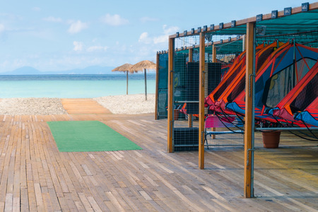 SSet of different color surf boards in a stack for rent by the beach in Lefkada, Greece