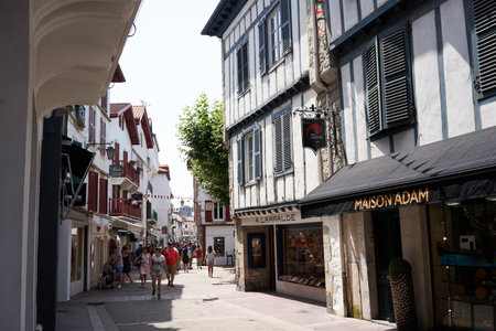 Saint Jean de Luz, France - July 22, 2019 - shopping in the narrow streets. Afternoon shopping in a beautiful small seaside resort from fashion boutiques to refreshing ice creamのeditorial素材