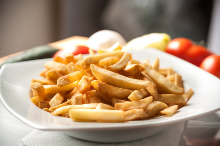 A plate of  taquitos with French fries