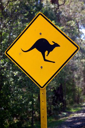 A kangaroo warning sign next to a rural road in Australia.の写真素材