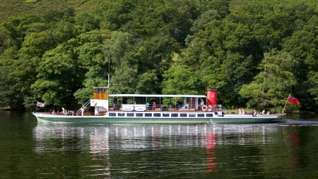 Tourists aboard the 'Raven' on Ullswater, in the English Lake District, on July 31, 2012. Although Ullswater Steamers have been sailing on the lake since 1859, the Raven was launched in 1889.のeditorial素材