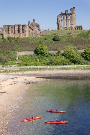 Tynemouth, UK, May 28, 2012 - Kayakers in front of Tynemouth Castle and Priory on the coast of North East England on May 28, 2012. The ancient buildings overlook the North Sea and the River Tyne.のeditorial素材