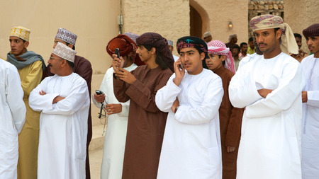 Omani men watching a tribal dance in Muscat, in the Sultanate of Oman.のeditorial素材