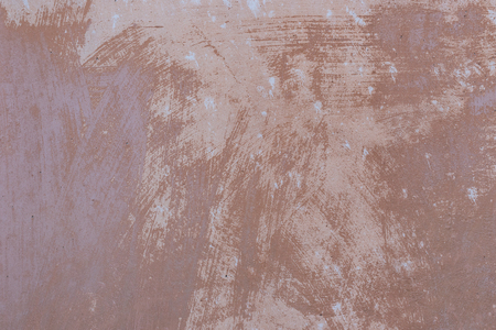 Image of a concrete wall in shades of brown, suitable for use as a background or texture.