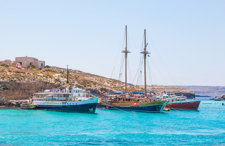Leisure boats loaded with tourists moored at the Blue Lagoon in Malta.