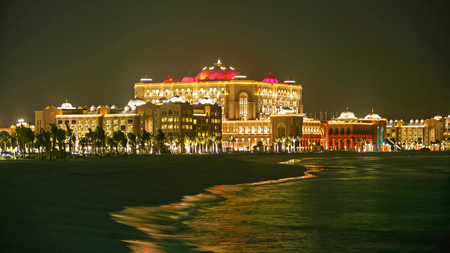 Abu Dhabi's colorful flagship hotel, the Emirates Palace, situated on the shores of the Arabian Gulf at night.のeditorial素材