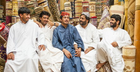 A group of unidentified male Pakistani salesmen at the carpet souk in Abu Dhabi, the capital city of the United Arab Emirates.のeditorial素材