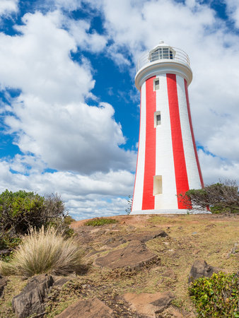 The Mersey Bluff Lighthouse standing at the mouth of the Mersey River, near Devonport in Tasmania, is unusual in Australia with its distinctive vertical red striped day mark.の写真素材