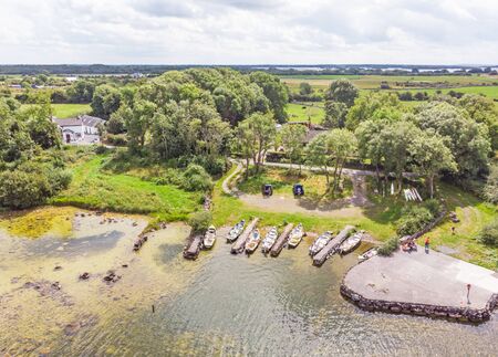COUNTY GALWAY, IRELAND - AUGUST 4, 2019: An aerial view of rowing boats at Keekill Bay near Headford in County Galway, Ireland.のeditorial素材