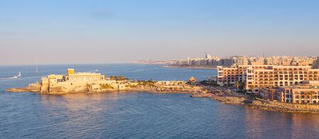 The entrance to St George's Bay in St Julian in Malta. Photo taken during the golden hour.の写真素材