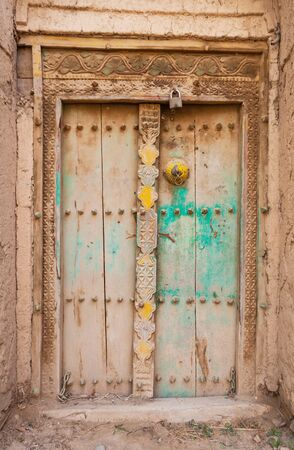 A colorful old door in the ruins of Birkat Al Mouz in the Nizwa area of Oman.の写真素材
