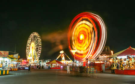 DUBAI, UAE - MARCH 4, 2005: Night-time attractions at the fun-fair at Dubai Global Village in Dubai in the United Arab Emirates.のeditorial素材
