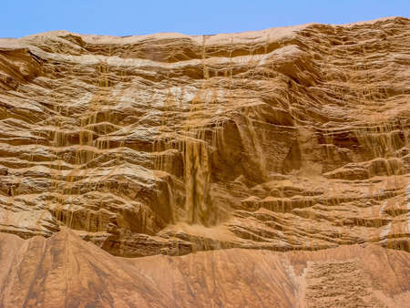 A 'waterfall' of sand cascading from a dune in the desert near Dubai in the United Arab Emirates.