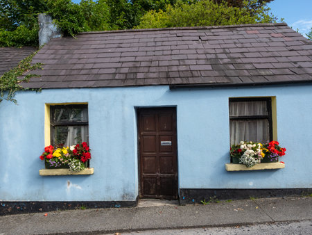 A blue traditional cottage in a street in Cong, on the border of County Galway and County Mayo in Ireland.の写真素材