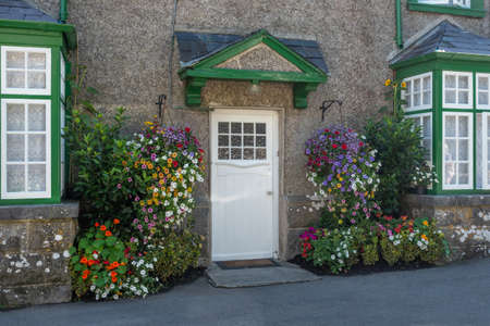 Flowers at the front door of a traditional house in the village of Cong, on the border of County Galway and County Mayo in Ireland.の写真素材