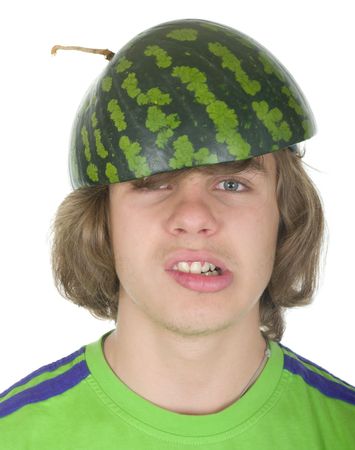 Teenager in a cap from a water-melon on a white backgroundの写真素材