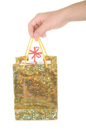 Hand holds  package with gifts on  white backgroundの写真素材