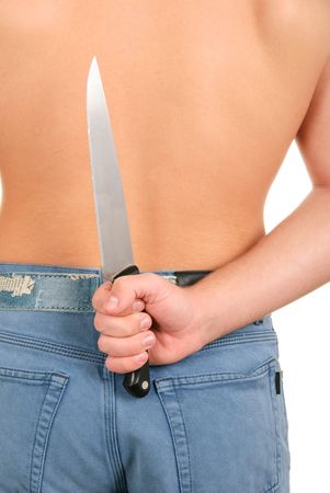 Hand hides knife for back on white backgroundの写真素材