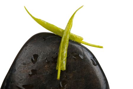 Tree leaves lie cross on stone isolated in whiteの写真素材