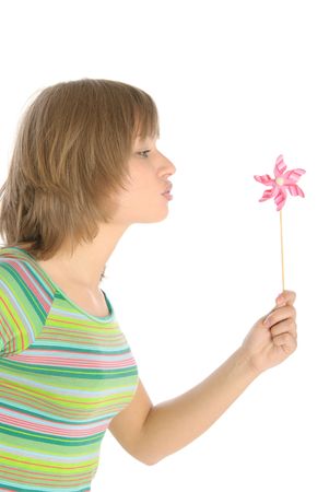 Young woman blows on weather vane isolated in whiteの写真素材