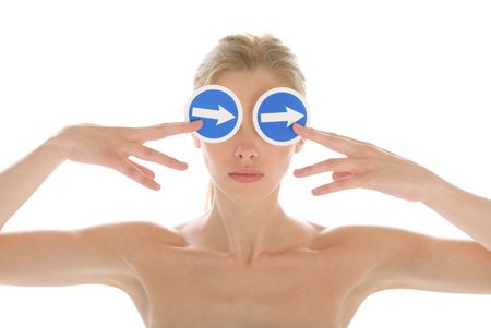 Young woman holds before arrow eyes isolated in whiteの写真素材