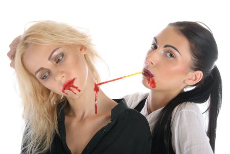 Woman sucks blood from neck of other woman isolated in whiteの写真素材