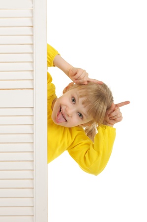 Girl puts out tongue in yellow jacketの写真素材