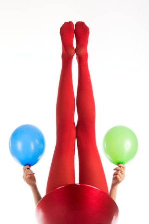 Female feet in red stockings with balloonsの写真素材