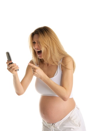 angry pregnant woman with mobile phoneの写真素材