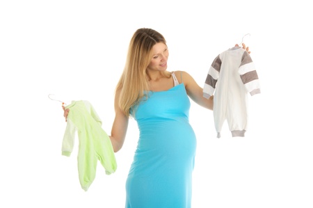 pregnant woman buying baby clothesの写真素材