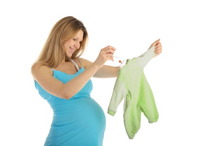 pregnant woman buying baby clothesの写真素材