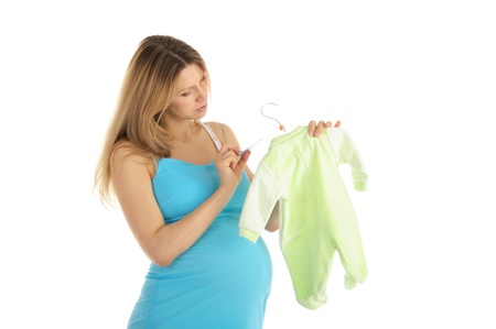 pregnant woman buying baby clothesの写真素材
