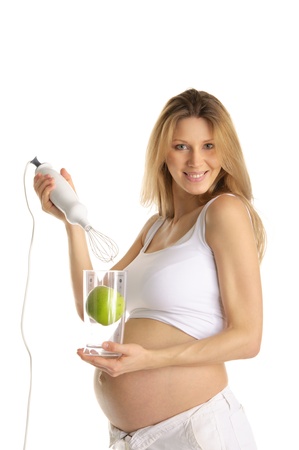pregnant woman with a blender and appleの写真素材