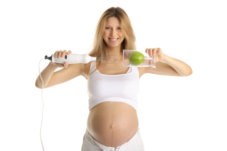 pregnant woman with a blender and appleの写真素材
