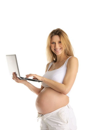Happy pregnant woman with laptopの写真素材