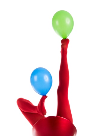 Legs with red tights juggling balloonの写真素材
