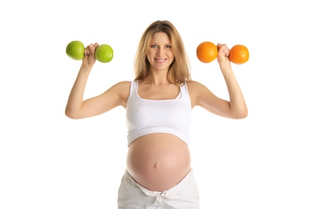 Pregnant woman involved in fitness dumbbellsの写真素材