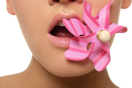 women hold in their teeth pink weathervaneの写真素材