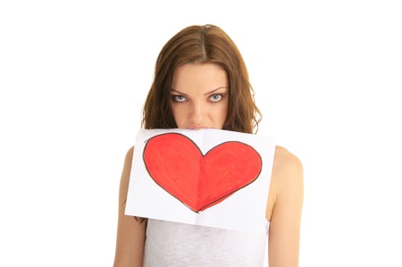 young woman holds in her teeth painted heartの写真素材