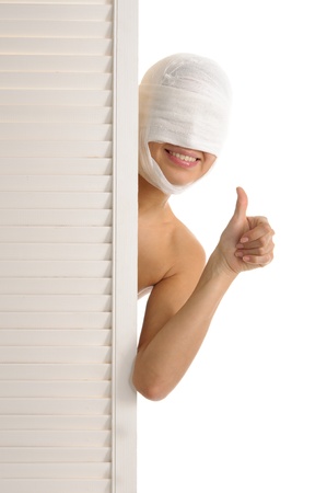 Satisfied woman with bandaged headの写真素材