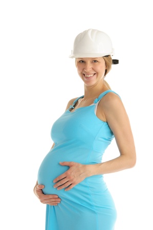 happy pregnant woman in helmetの写真素材