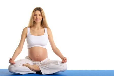 pregnant woman with ??eyes closed practicing yogaの写真素材