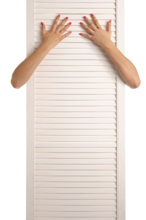 Female feet in red stockings, hands and doorの写真素材