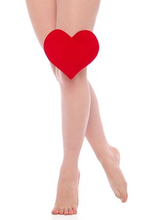 female legs with red heartの写真素材