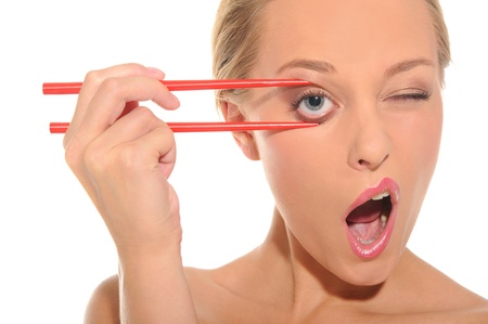 Surprised woman opens her eyes chopsticksの写真素材