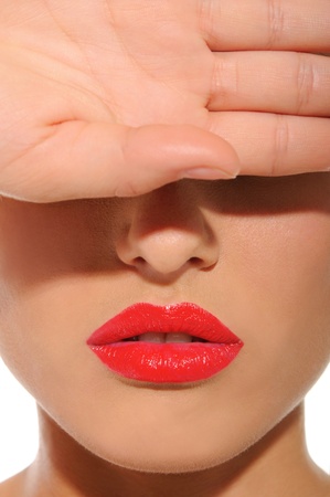 woman with red lips closes his eyes with handの写真素材