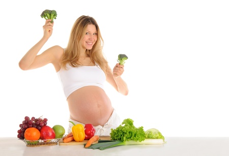 Dancing pregnant woman with fruits and vegetables isolated on whiteの写真素材